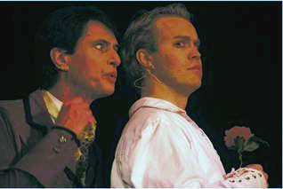 Lord Henry, played by Ken Hermens, whispers sweet nothings into the ear of Dorian Gray, played by Jason Bailey in 